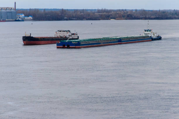 istock Cargo ship and barge sailing on the river Dnieper 900945432