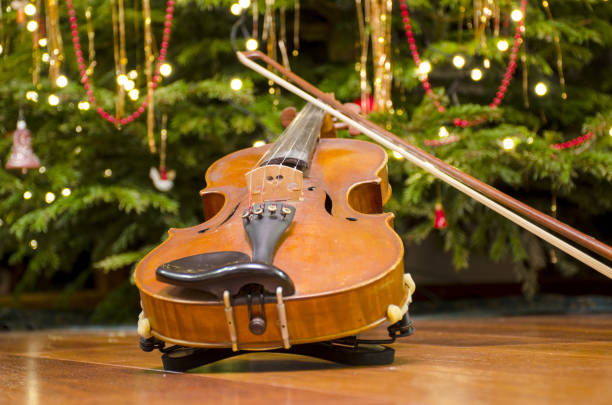 istock The violin front of a Christmas tree with decoration. 900945808