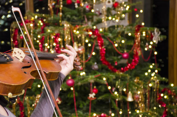 istock The violin front of a Christmas tree with decoration. 900945810