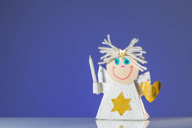 istock A child's handicraft angel with a candle 900945878