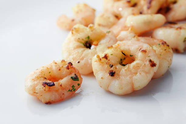 istock grilled prawns or shrimps with spices on a light gray background, copy space 900954544