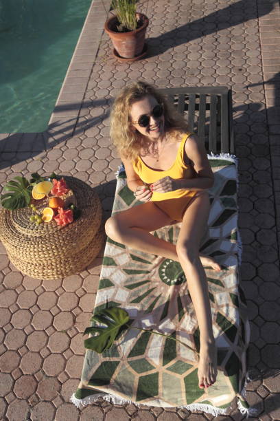 istock Woman by the pool. 900961768