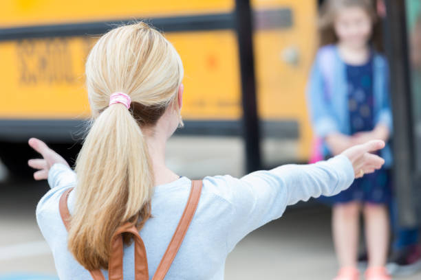 istock Excited mom waits for daughter after school 900966126