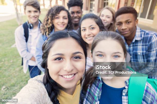 Diverse Group Of Teens Looking At Camera Taking Selfie At High School Stock Photo - Download Image Now