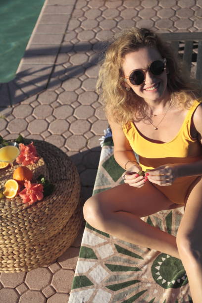 istock Woman by the pool. 900969200