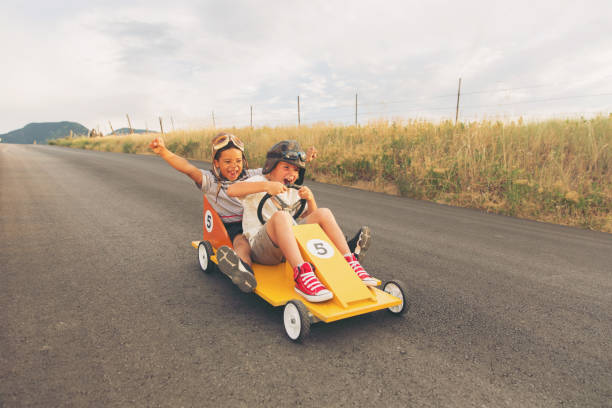 istock Young Boys Racing Homemade Car 900969268
