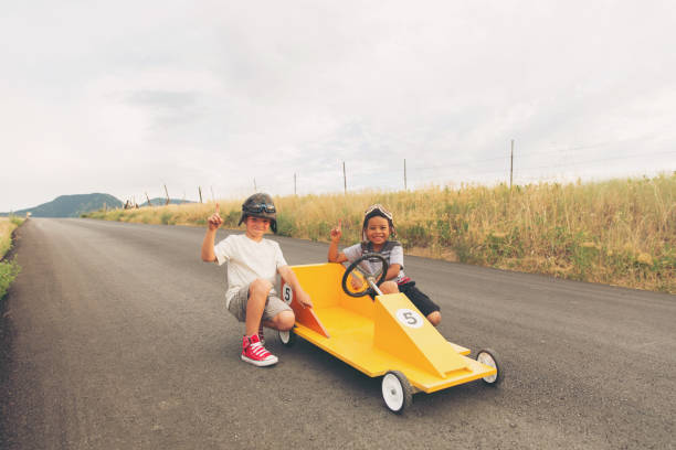 istock Young Boys Racing Homemade Car 900969550