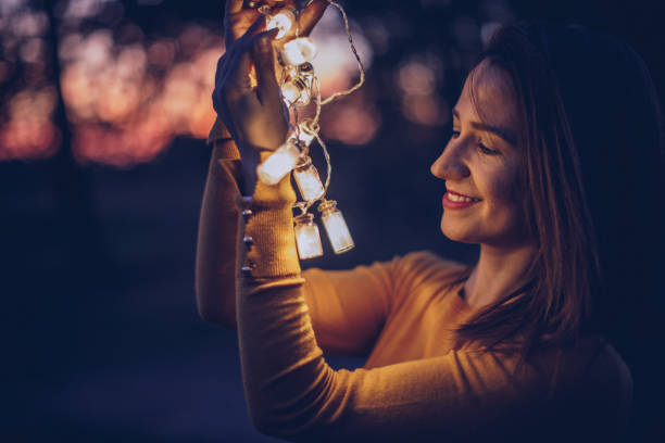 istock Smiling woman outdoors with lights 900977114