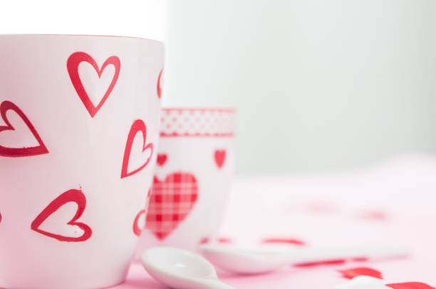 istock Tea and coffee cup sorrounded by white and red hearts 900979266