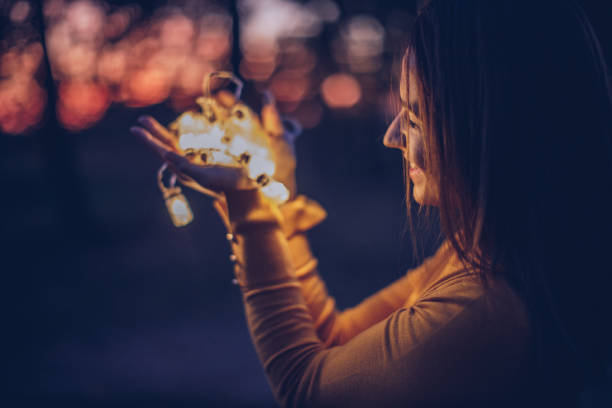 istock Woman outdoors with lights 900979588