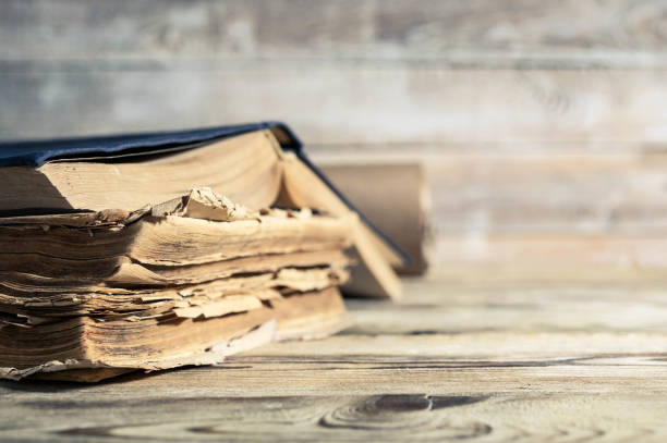 istock Old books on a wooden table. Selective focus. Retro toning 900983746