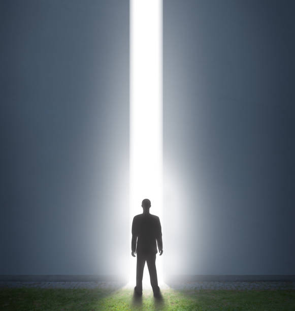 istock Man and door open to future possibilities 900987308