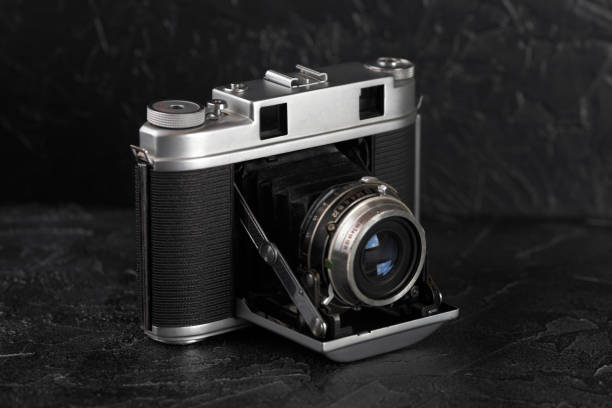 istock The vintage medium format film camera on black cement background. 900987436