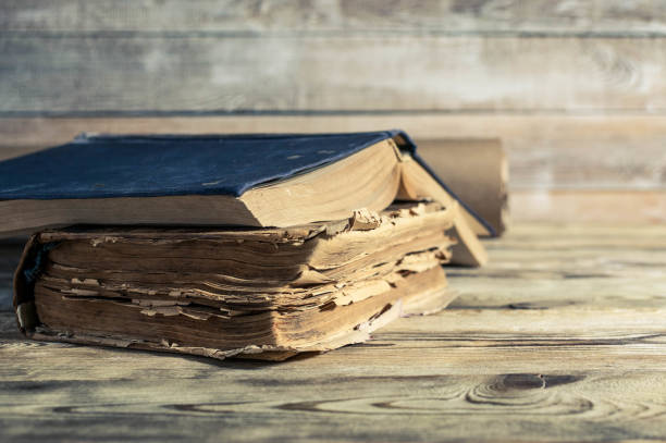 istock Old books on a wooden table. Selective focus. Retro toning 900987458