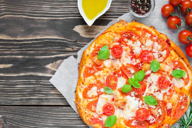 istock Pizza Margherita with tomatoes, basil and mozzarella cheese 900991028