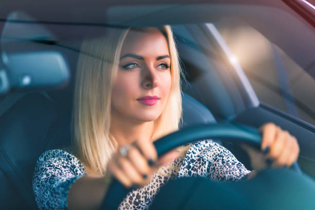 istock Young woman driving a car 901001408
