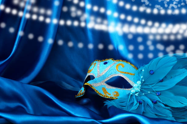 istock Image of elegant venetian mask over blue silk background. 901031502