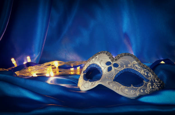 istock Image of elegant venetian mask over blue silk background. 901031508
