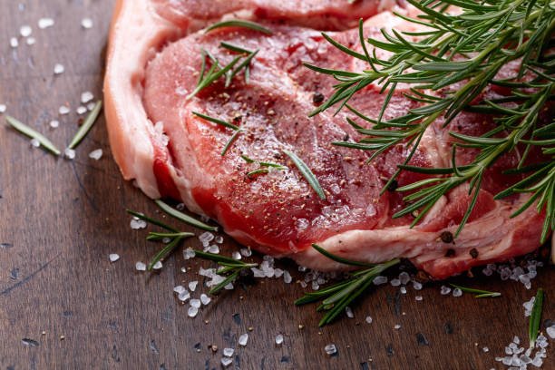 istock Raw pork with rosemary . 901031596