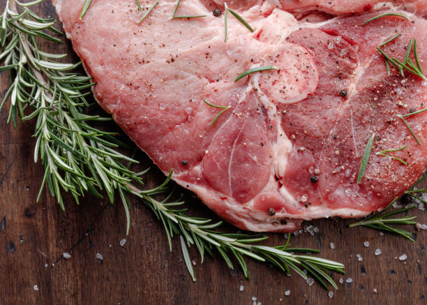 istock Raw pork with rosemary . 901031622