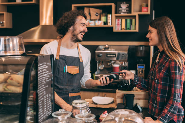 istock Customer paying with a smart phone at a coffee shop 901032022