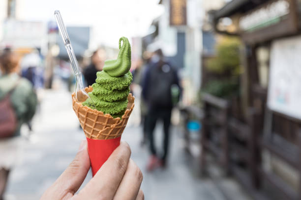 istock Hand holding Matcha green tea with milky vanilla soft ice Cream Cone 901038926