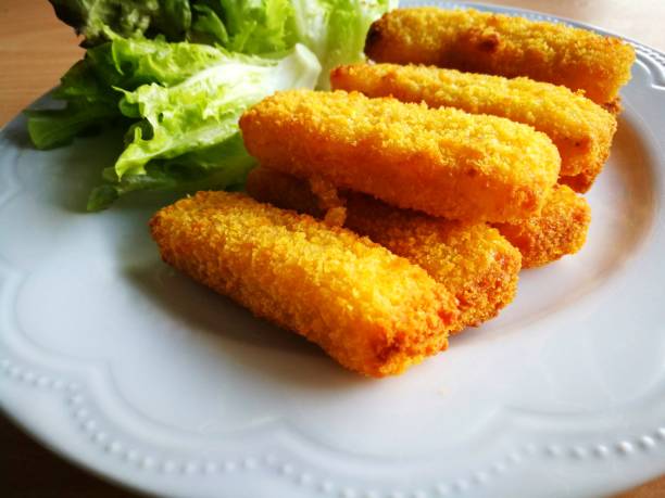 istock Delicious fish fingers on white plate - perspective view. 901045916