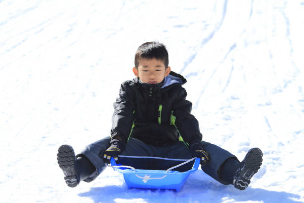 istock Japanese boy on the sled (second grade at elementary school) 901045960