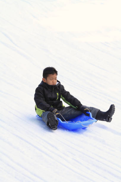 istock Japanese boy on the sled (second grade at elementary school) 901045990