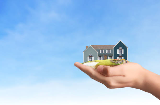 istock Mortgage concept by house from  hand 901059810