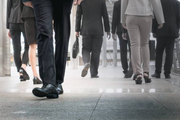 istock businessman legs walking go forward as outstanding by other legs walking as opposite direction on business street 901060362