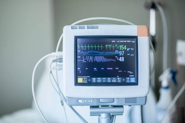 Medical vital signs monitor in a hospital Medical vital signs monitor instrument in a hospital. This health care device displays and monitors heart rate and oxygen levels in hospital patients electrocardiography photos stock pictures, royalty-free photos & images