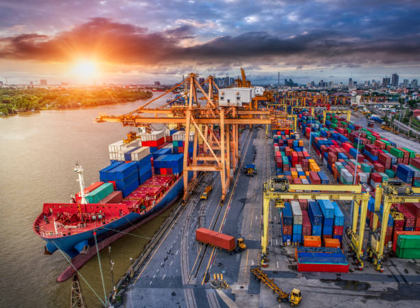 istock Logistics and transportation of Container Cargo ship and Cargo plane with working crane bridge in shipyard at twilight, logistic import export and transport industry background 901067800