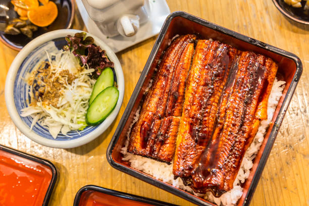 istock Unagi, cooked Japanese fresh water eel, over rice - a popular Japanese dish 901070450