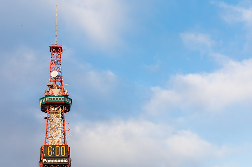 SAPPORO, JAPAN: AUGUST 1, 2017: The 147-m Sapporo TV Tower and clock along Odori Park is a landmark visible all over the capital of Hokkaido and largest city in north Japan. Observation deck at 90 m.