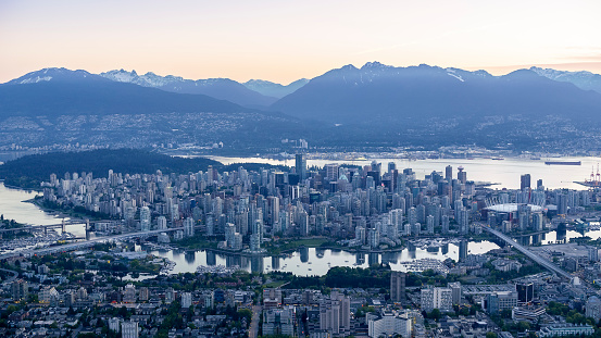 Exterior of modern cityscape with BC Place, mountains in background, Vancouver, British, Columbia, Canada.