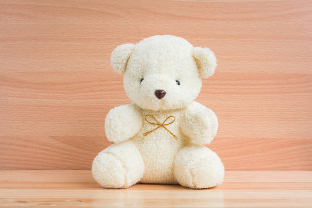 istock Bear and cup on brown wood background 901081906