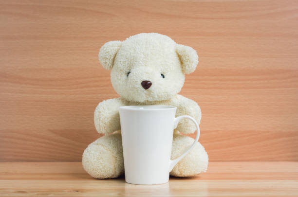 istock Bear and cup on brown wood background 901081926