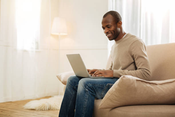 istock Gleeful man typing on the laptop 901082362