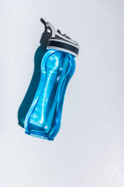 sports bottle with water on grey