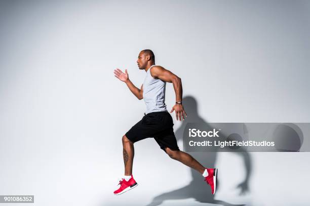 Sportsman Running On Grey Stock Photo - Download Image Now - Activity, Adult, Adults Only