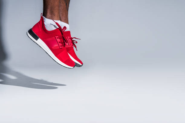 istock sportsman in sneakers jumping on grey 901088566