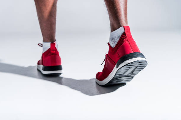 istock man in sports shoes on grey 901088794