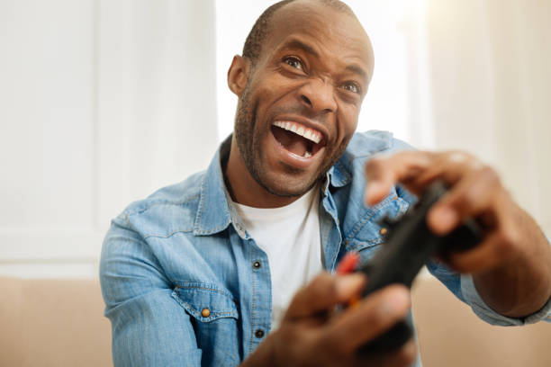 istock Gleeful man laughing and playing a game 901088796