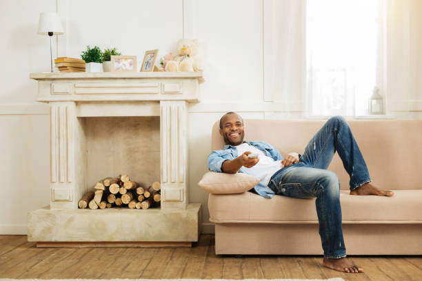 istock Exuberant man relaxing on the sofa at weekend 901088854