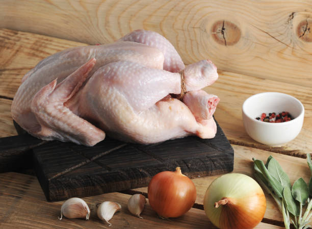 istock whole raw chicken carcass on the Board and spices 901089620