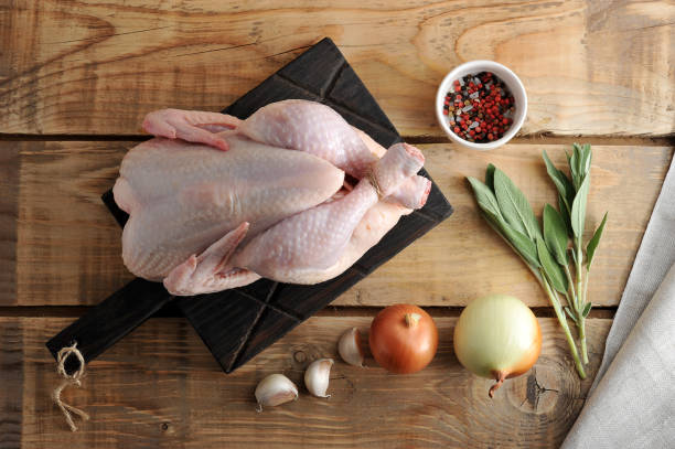 istock A whole raw chicken carcass with associated twine feet on wooden rustic background 901089662