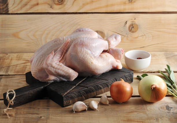 istock whole raw chicken carcass on the Board and spices 901089690
