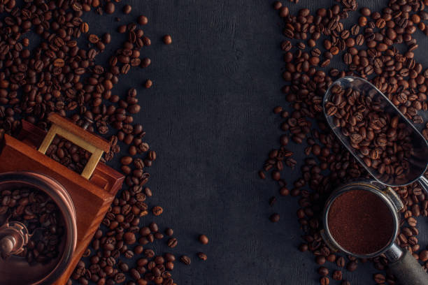 istock roasted coffee beans, coffee grinder and scoop on black 901089946