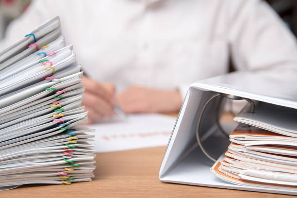 istock A pile of documents with the man in the document 901092672